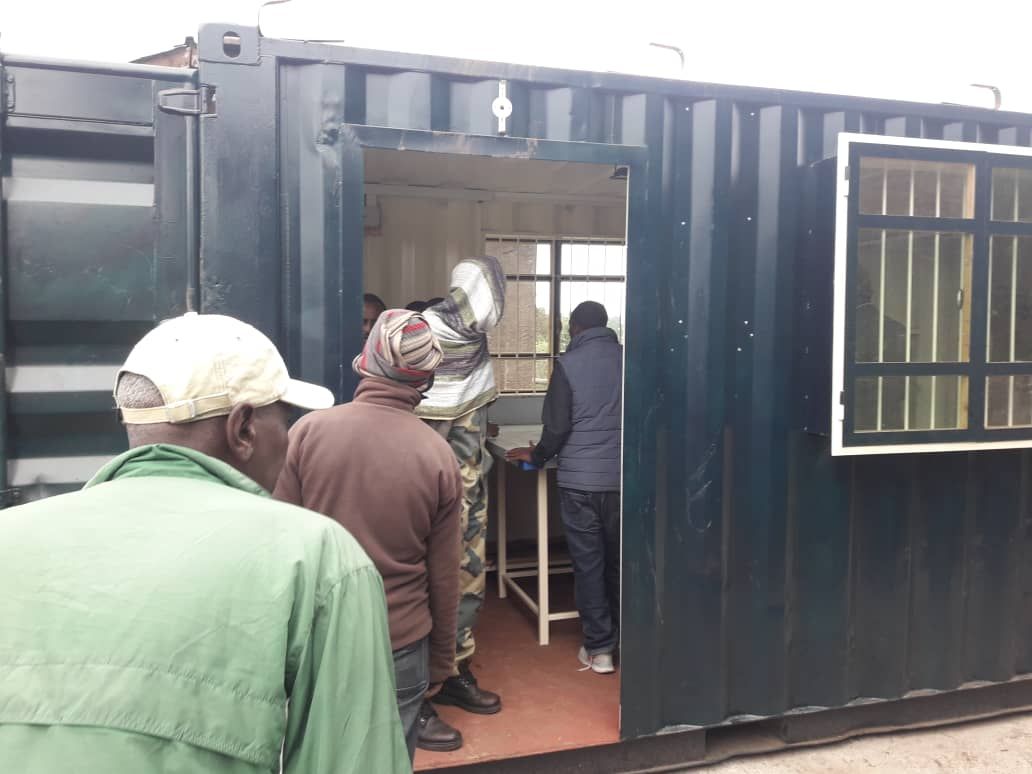 Several people enter a refurbished shipping container to look around