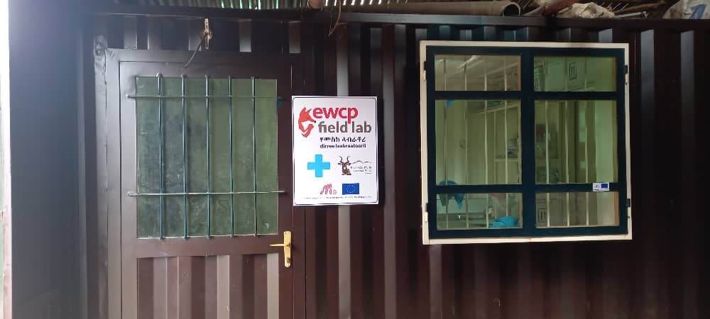 Lab door and window with sign saying EWCP field lab